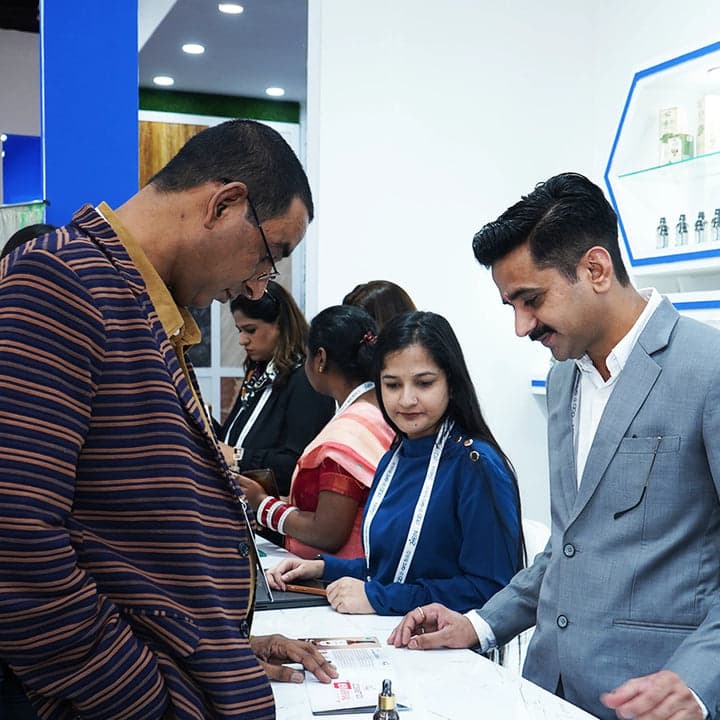 The Vedobi team with customers at an exhibition stand